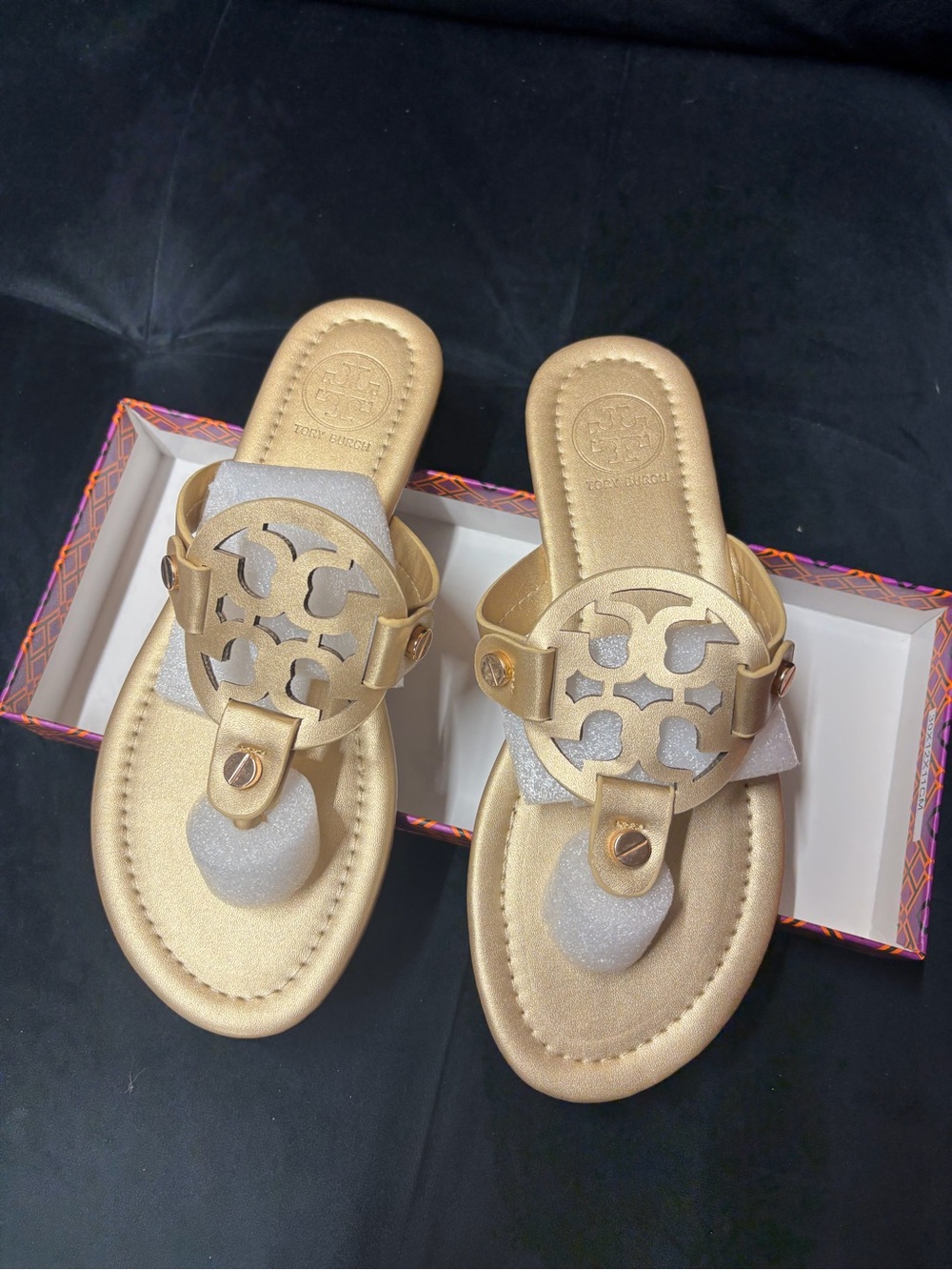 Women's Metallic Gold Toe-Post Sandals with Decorative Cutout Emblem